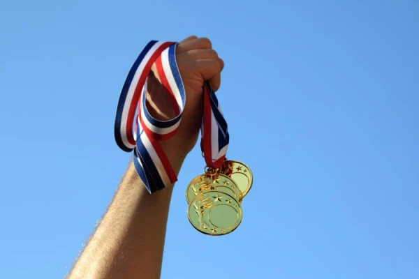 Who in sports invented the tradition of biting medals?