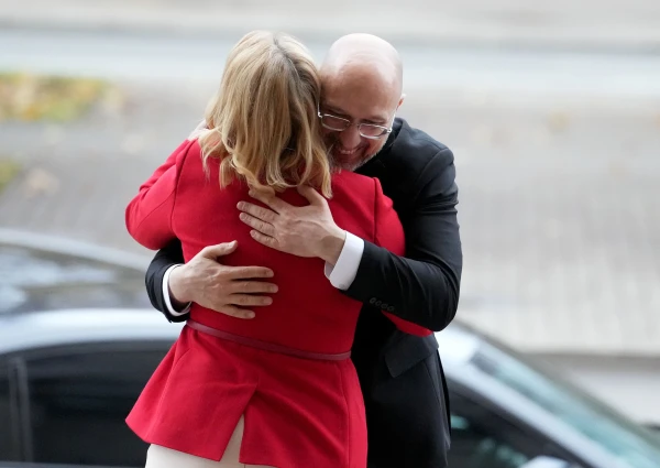 Премьер Силиня (стоит спиной) тепло встретила министра Шмыгаля (в очках).