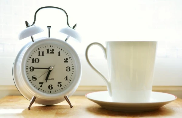 When was the first alarm clock invented and how did people wake up on time before?