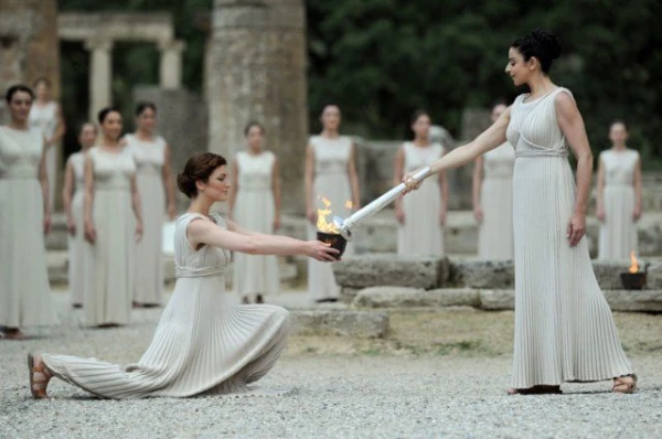 Who is entrusted with igniting the flame of the 2026 Olympic Games?