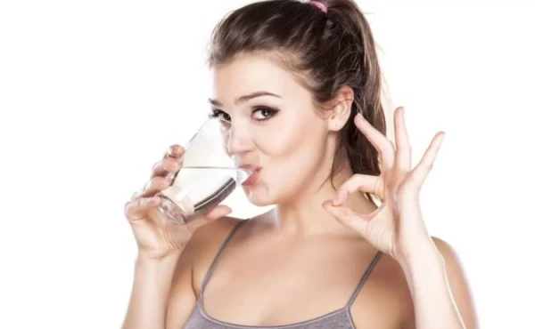 What are the benefits of drinking warm water on an empty stomach?