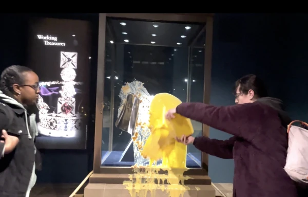 Protesters at the Tower of London smeared the crown display with cream and apple dessert