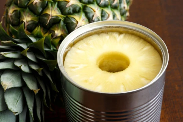 Why is it not recommended to consume juice from canned pineapples?
